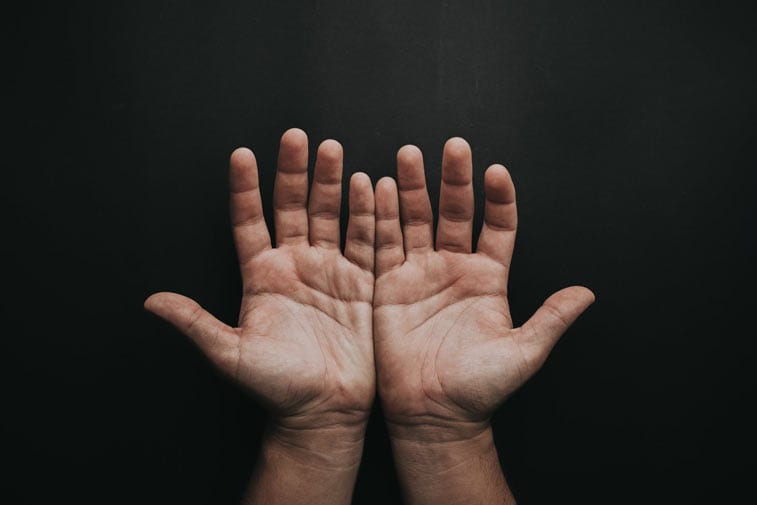 two hands held palms facing the camera