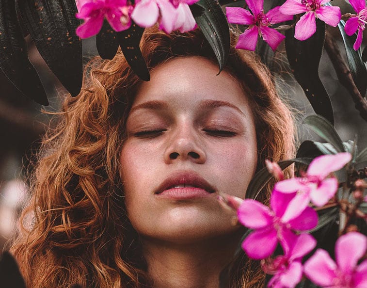 a woman breathing in a forest of flowers