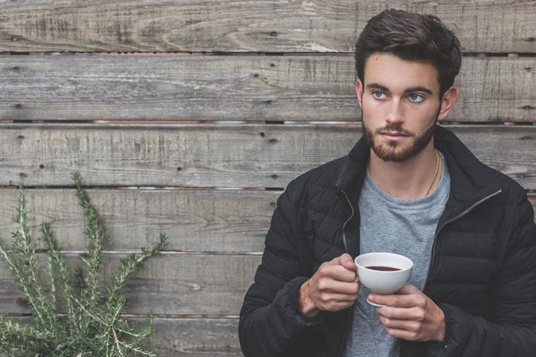 a man holding a cup of coffee