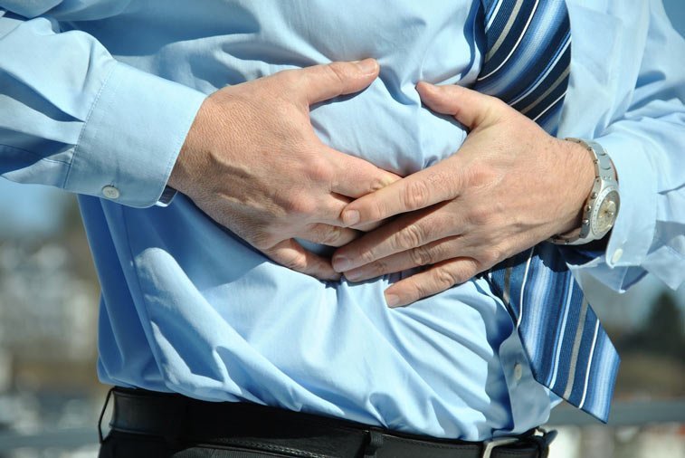 a man clutching his stomach
