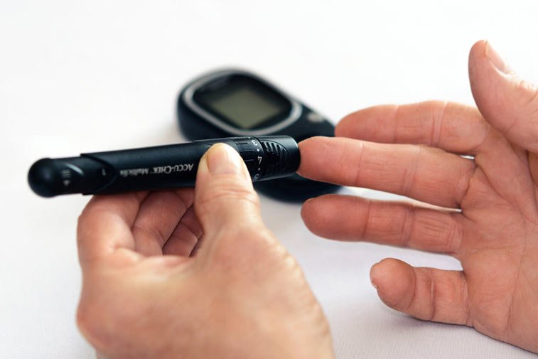 person testing blood sugar