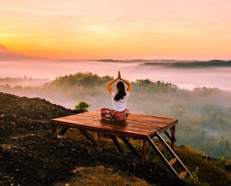 woman doing yoga at sunrise