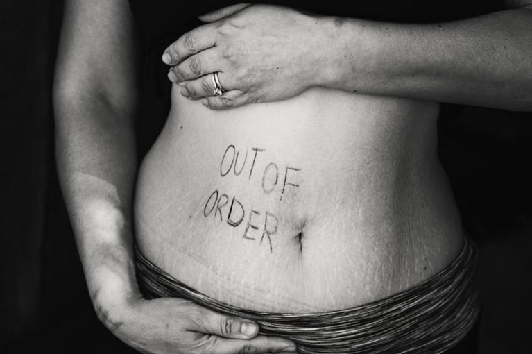 the words "out of order" written across a stomach