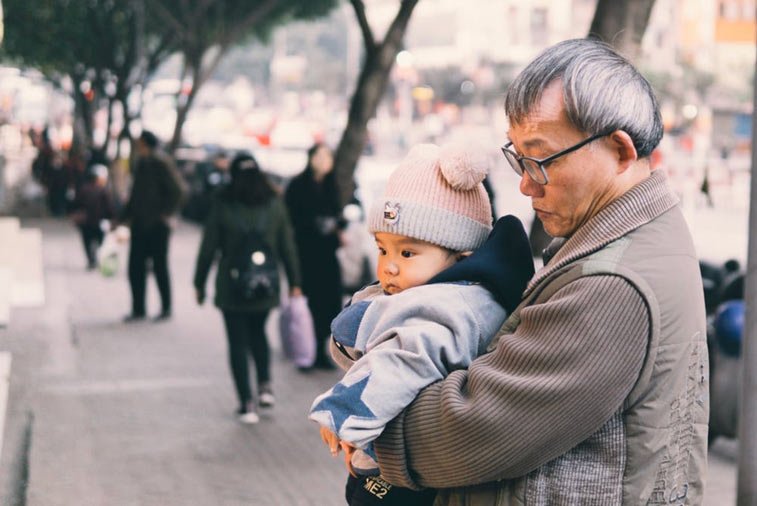 a grandfather holding his grandchild